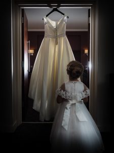 bridesmaid looking at wedding dress